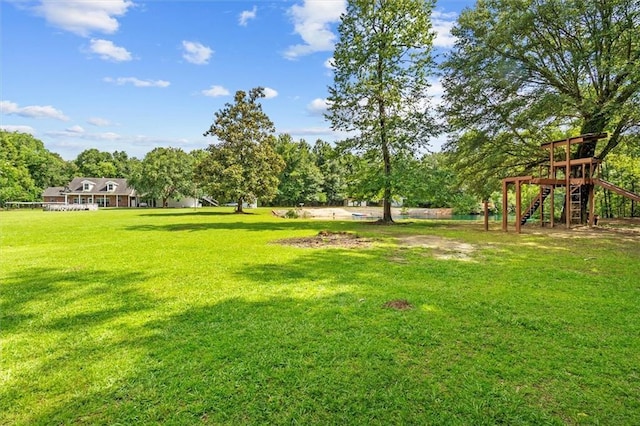23375 Lowe Davis Rd, Covington, LA 70435 - view of grassy yard with a playground and view of wooded area
