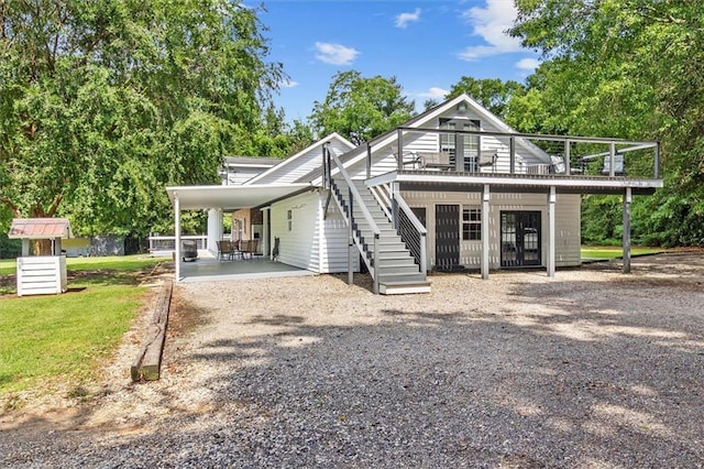 23375 Lowe Davis Rd, Covington, LA 70435 - view of front of home featuring driveway, a wooden deck, a carport, and stairway