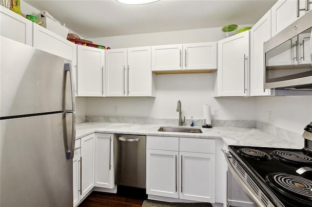 1422 Dauphine St Unit 8, New Orleans, LA 70116 - kitchen with appliances with stainless steel finishes, a sink, white cabinetry, and dark wood finished floors