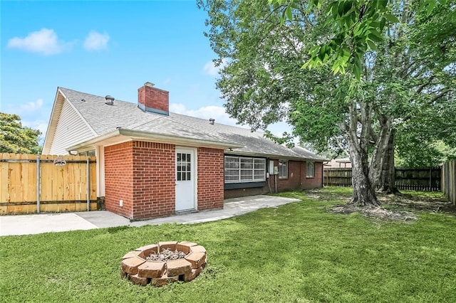414 Pine Forest Dr, Slidell, LA 70458 - back of property with a chimney, brick siding, a patio, an outdoor fire pit, and roof with shingles