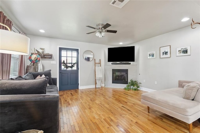 2300 Fenelon St, Chalmette, LA 70043 - living room featuring a ceiling fan, light wood finished floors, baseboards, a glass covered fireplace, and recessed lighting