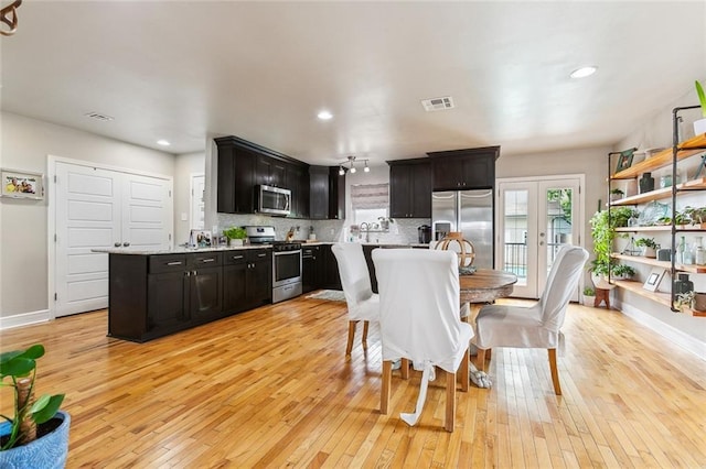 2300 Fenelon St, Chalmette, LA 70043 - dining room featuring light wood-style floors, french doors, recessed lighting, and baseboards
