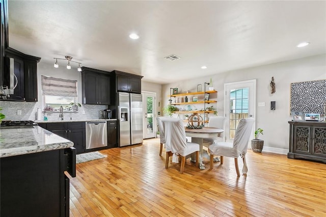 2300 Fenelon St, Chalmette, LA 70043 - dining room with healthy amount of natural light, light wood-type flooring, baseboards, and recessed lighting