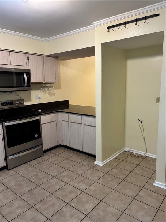 2836 Steamship Cir Unit A, River Ridge, LA 70123 - kitchen featuring stainless steel appliances, dark countertops, crown molding, light tile patterned floors, and light brown cabinets