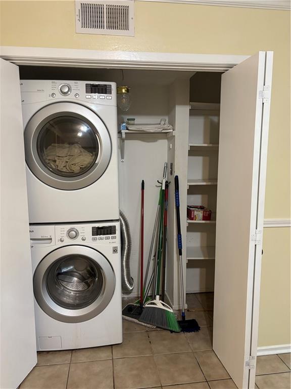 2836 Steamship Cir Unit A, River Ridge, LA 70123 - laundry area with estacked washer and dryer and light tile patterned floors