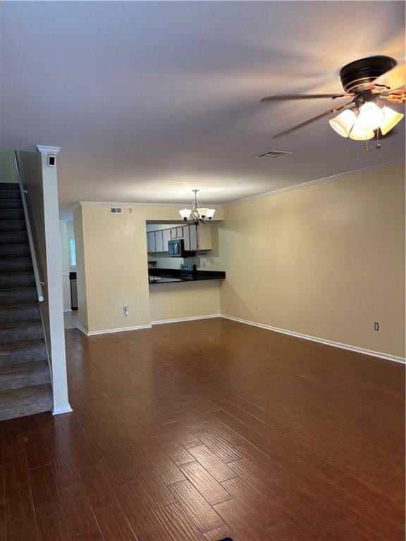 2836 Steamship Cir Unit A, River Ridge, LA 70123 - unfurnished living room with stairway, a chandelier, dark wood-type flooring, baseboards, and crown molding