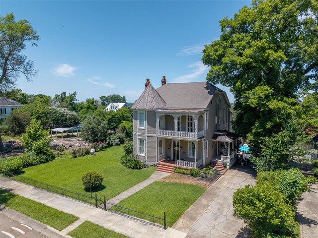 212 Linton Ave, Natchez-Ms, MS 39120 - victorian house featuring a porch, a balcony, a chimney, and concrete driveway