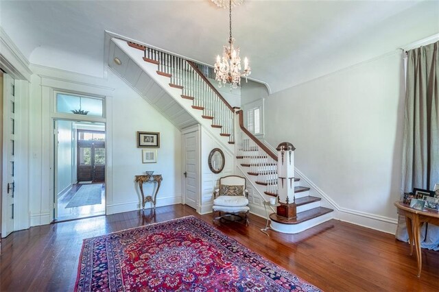 212 Linton Ave, Natchez-Ms, MS 39120 - foyer featuring stairway, wood finished floors, a chandelier, and baseboards