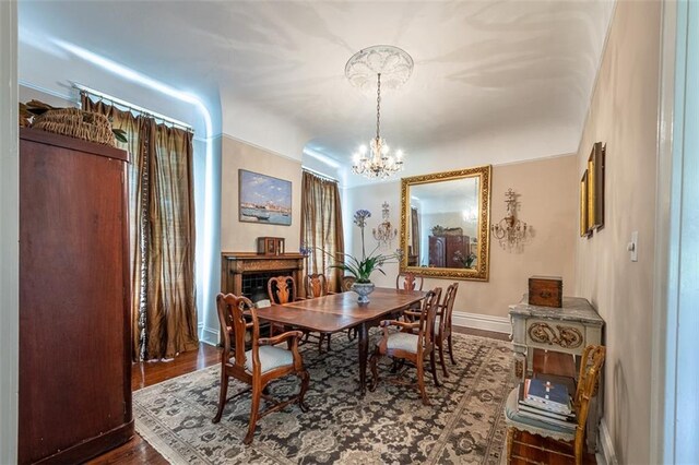 212 Linton Ave, Natchez-Ms, MS 39120 - dining room featuring baseboards, a chandelier, and wood finished floors
