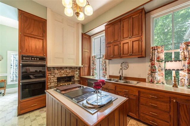 212 Linton Ave, Natchez-Ms, MS 39120 - kitchen with a sink, a chandelier, light countertops, and brown cabinets