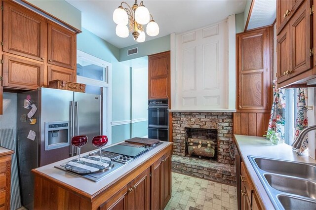 212 Linton Ave, Natchez-Ms, MS 39120 - kitchen featuring a sink, stainless steel fridge with ice dispenser, brown cabinetry, and light countertops
