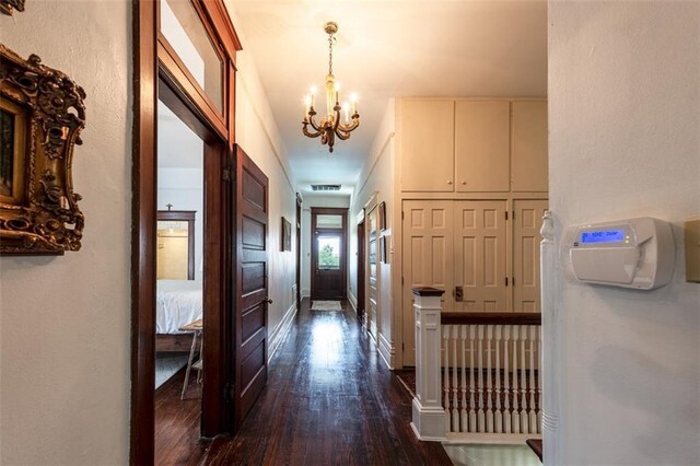 212 Linton Ave, Natchez-Ms, MS 39120 - hall with a chandelier, dark wood-type flooring, and baseboards