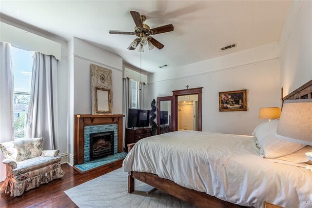 212 Linton Ave, Natchez-Ms, MS 39120 - bedroom with wood finished floors and a fireplace