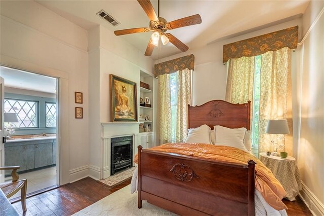 212 Linton Ave, Natchez-Ms, MS 39120 - bedroom with dark wood-style flooring, a fireplace with flush hearth, baseboards, and ceiling fan