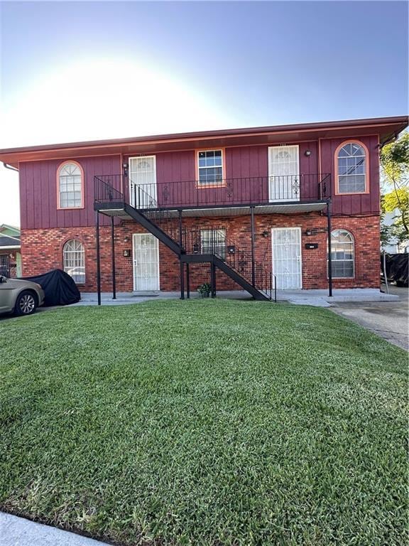 70915 S Gayoso St, New Orleans, LA 70119 - view of front of house with stairs, a front lawn, and brick siding