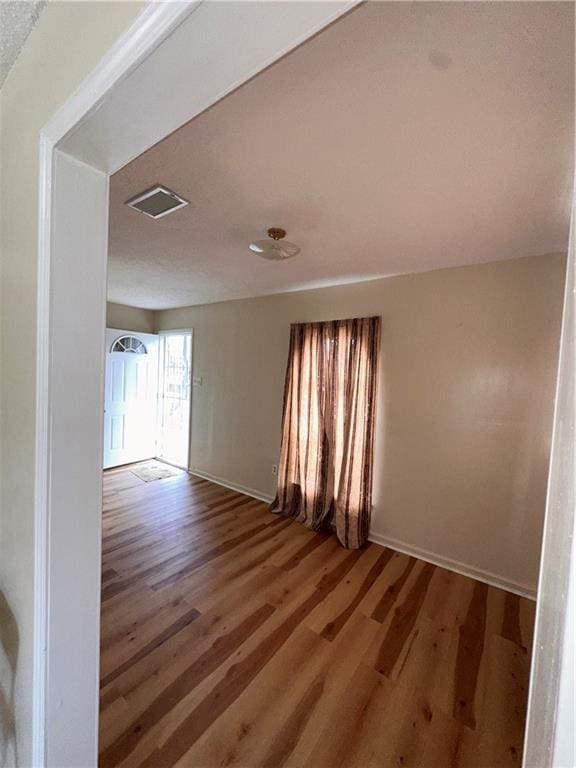 70915 S Gayoso St, New Orleans, LA 70119 - empty room featuring wood finished floors and baseboards