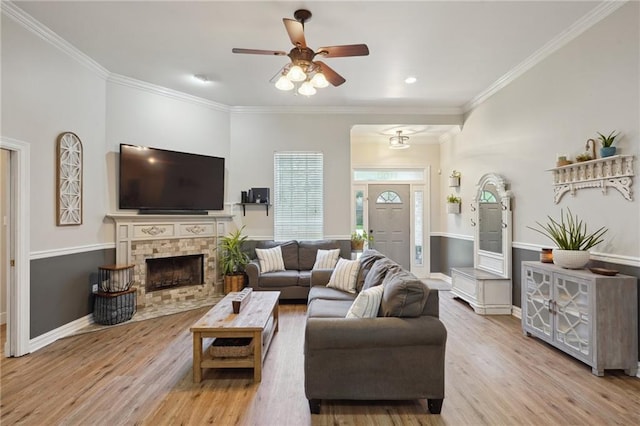 1400 Viola St, Mandeville, LA 70448 - living area with wood finished floors, a ceiling fan, ornamental molding, baseboards, and a fireplace