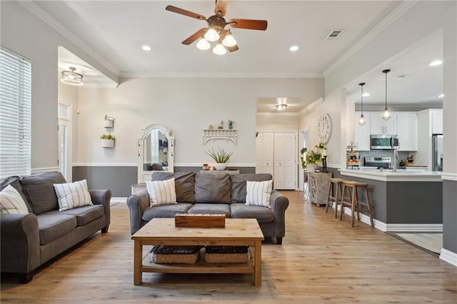 1400 Viola St, Mandeville, LA 70448 - living room featuring ceiling fan, light wood finished floors, crown molding, and recessed lighting