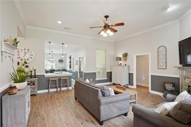1400 Viola St, Mandeville, LA 70448 - living room featuring a ceiling fan, light wood-style flooring, baseboards, crown molding, and recessed lighting