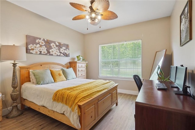 1400 Viola St, Mandeville, LA 70448 - bedroom with light wood finished floors, baseboards, an office area, and ceiling fan
