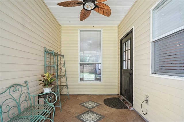 1400 Viola St, Mandeville, LA 70448 - view of exterior entry with a ceiling fan and a patio area