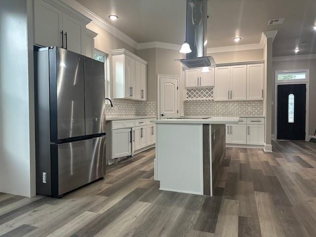 1731 Pratt Dr, New Orleans, LA 70122 - kitchen with freestanding refrigerator, island exhaust hood, ornamental molding, light countertops, and dark wood-type flooring