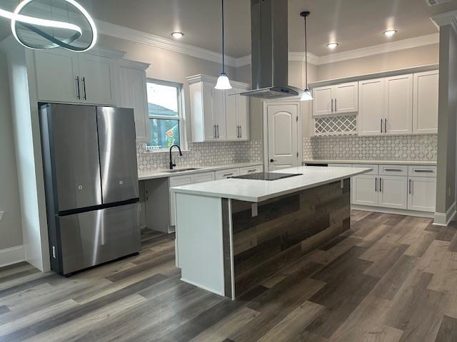 1731 Pratt Dr, New Orleans, LA 70122 - kitchen featuring freestanding refrigerator, island range hood, a sink, crown molding, and light countertops