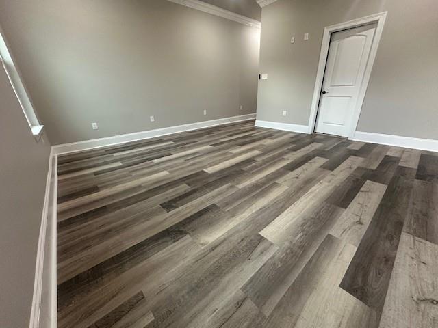 1731 Pratt Dr, New Orleans, LA 70122 - unfurnished room with ornamental molding, dark wood finished floors, and baseboards