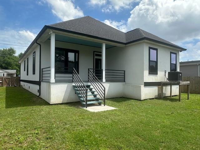 1731 Pratt Dr, New Orleans, LA 70122 - rear view of house featuring stairway, a porch, and roof with shingles