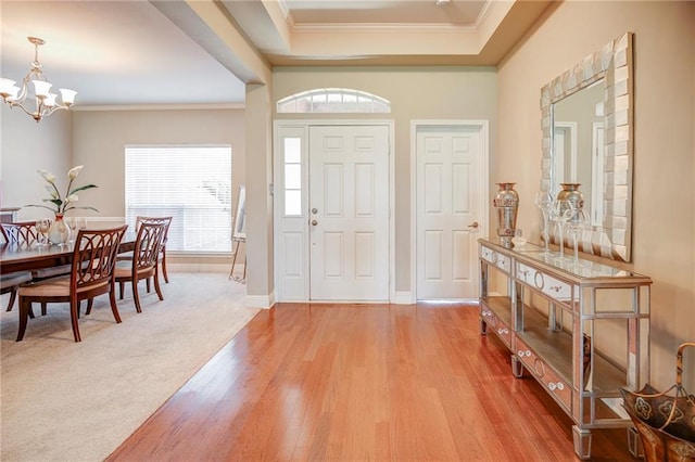 39070 Pirogue Ave, Gonzales, LA 70737 - foyer with a chandelier, ornamental molding, light wood-style floors, and baseboards