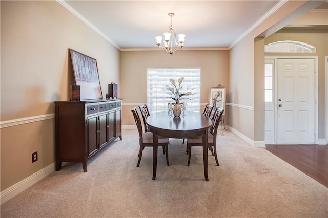 39070 Pirogue Ave, Gonzales, LA 70737 - dining space with a chandelier, crown molding, light colored carpet, and baseboards