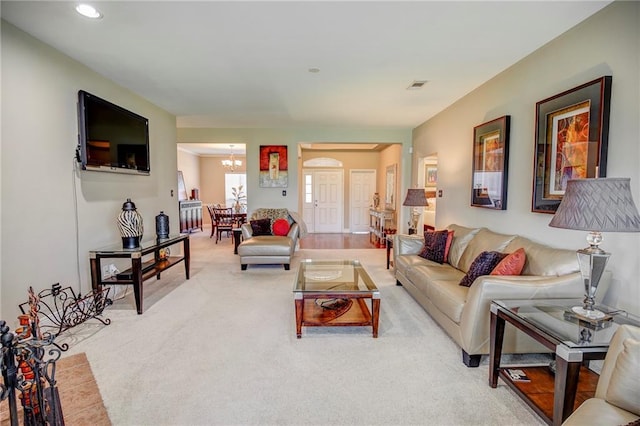 39070 Pirogue Ave, Gonzales, LA 70737 - living room featuring a chandelier, light carpet, recessed lighting, and arched walkways