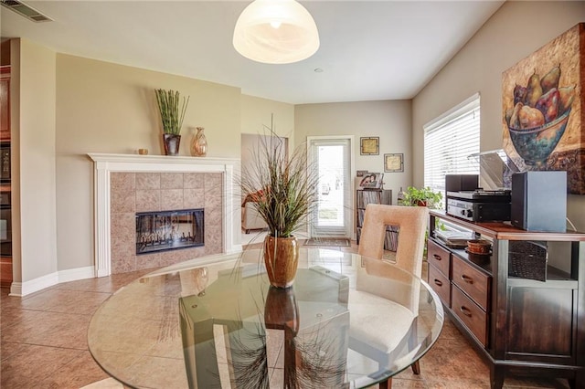 39070 Pirogue Ave, Gonzales, LA 70737 - tiled dining space with a tiled fireplace and baseboards
