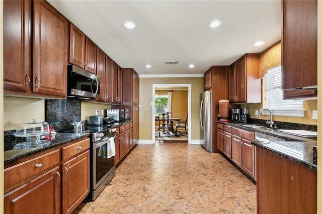 1825 Lake Superior Dr, Harvey, LA 70058 - kitchen with stainless steel appliances, a sink, ornamental molding, baseboards, and backsplash