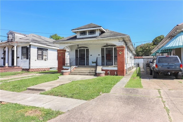 233537 Jasmine St, New Orleans, LA 70122 - view of front of house with covered porch, brick siding, and concrete driveway