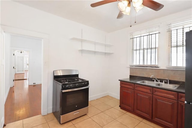 233537 Jasmine St, New Orleans, LA 70122 - kitchen with appliances with stainless steel finishes, a sink, a ceiling fan, dark countertops, and open shelves