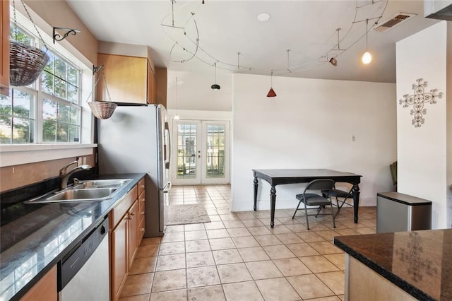 719 Atlantic Ave, New Orleans, LA 70114 - kitchen with a sink, stainless steel appliances, french doors, dark countertops, and light tile patterned floors