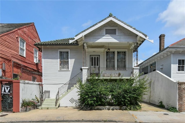 1311 Bourbon St, New Orleans, LA 70116 - view of front facade featuring stairs and covered porch
