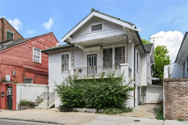1311 Bourbon St, New Orleans, LA 70116 - view of front of house featuring a balcony, an attached garage, and driveway