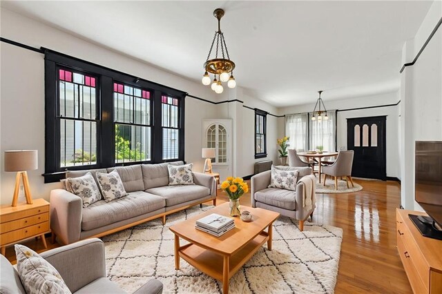 1311 Bourbon St, New Orleans, LA 70116 - living room featuring a chandelier and wood finished floors