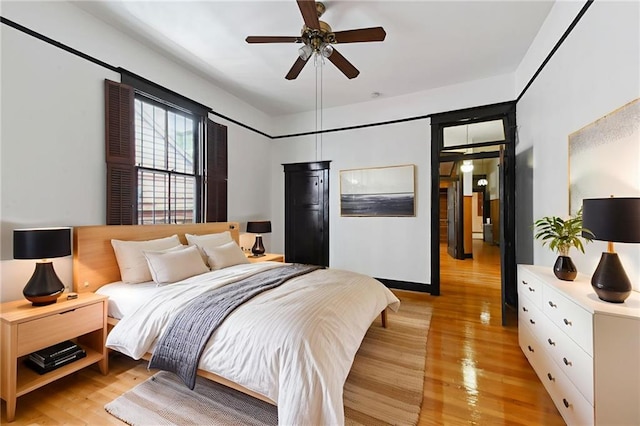 1311 Bourbon St, New Orleans, LA 70116 - bedroom featuring light wood-type flooring and ceiling fan