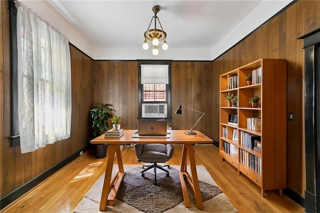 1311 Bourbon St, New Orleans, LA 70116 - home office featuring light wood-type flooring, cooling unit, and wood walls
