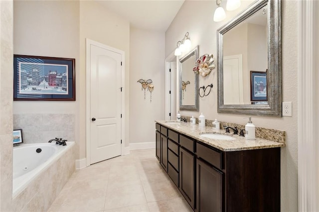 bathroom featuring double vanity, tile patterned flooring, a whirlpool tub, and baseboards