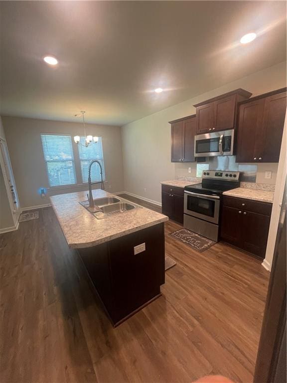 47715 Cathy Ln, Robert, LA 70455 - kitchen featuring appliances with stainless steel finishes, a sink, dark brown cabinetry, a kitchen island with sink, and recessed lighting