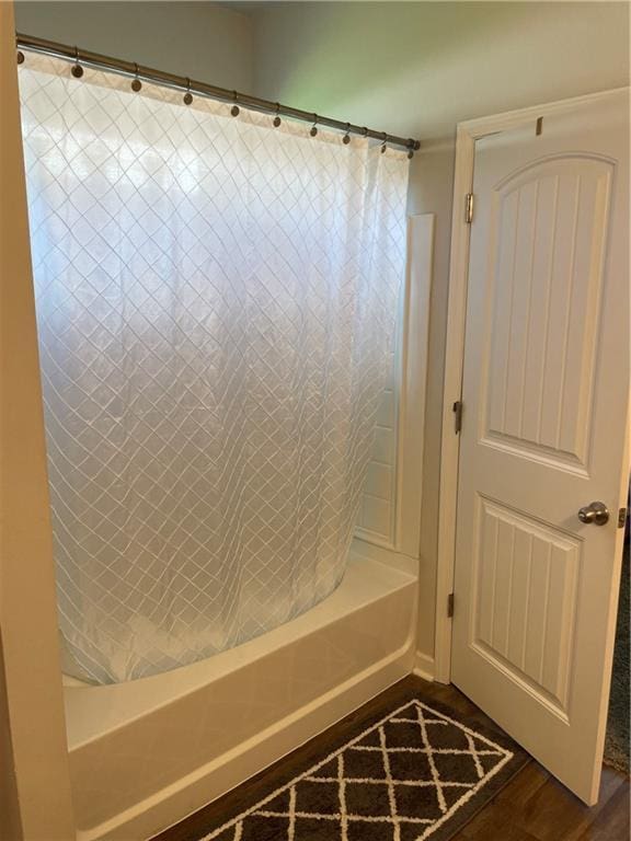 47715 Cathy Ln, Robert, LA 70455 - bathroom featuring shower / bathtub combination with curtain and wood finished floors