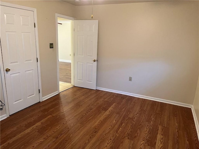 213 4th St, Chalmette, LA 70043 - empty room with dark wood-style flooring and baseboards
