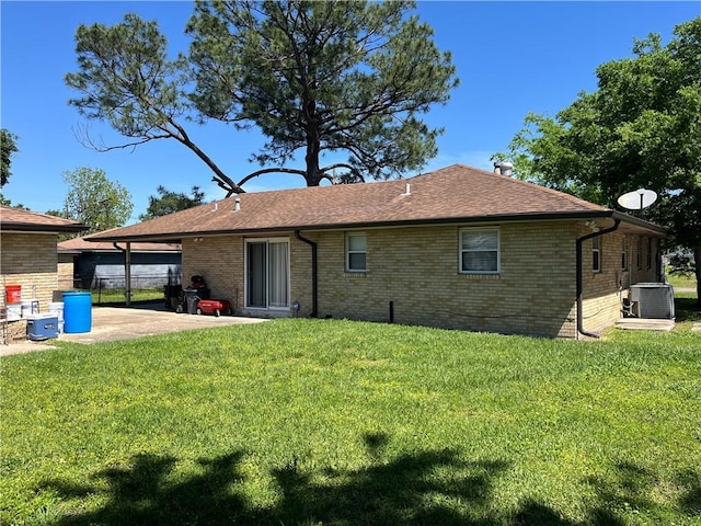 213 4th St, Chalmette, LA 70043 - back of property featuring a patio, brick siding, and a shingled roof
