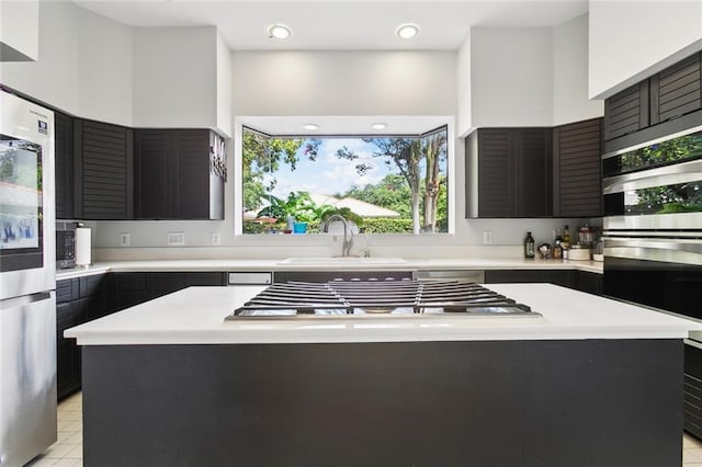 3213 Tolmas Dr, Metairie, LA 70002 - kitchen with a sink, light countertops, stainless steel appliances, and a kitchen island