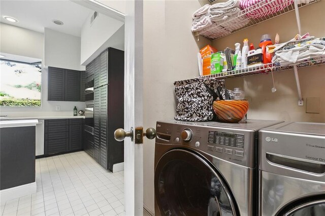 3213 Tolmas Dr, Metairie, LA 70002 - laundry room featuring independent washer and dryer, light tile patterned flooring, and baseboards