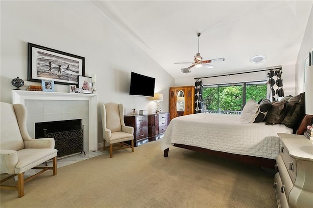 3213 Tolmas Dr, Metairie, LA 70002 - carpeted bedroom with vaulted ceiling, a tiled fireplace, and a ceiling fan